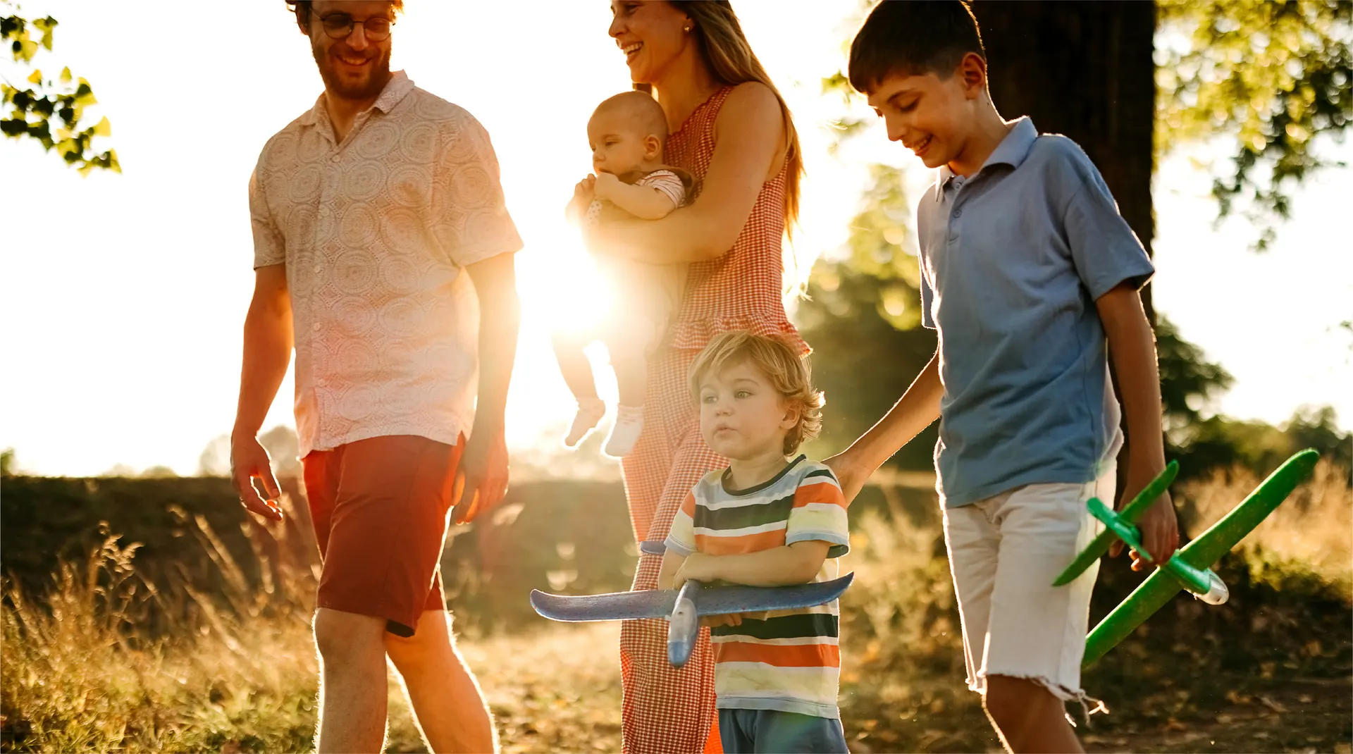 Lifestyle photograph labelled caledon-station in the Bolton Place marketing set — a family walking outdoors near Bolton, Caledon. Not a rendering of a detached house or a GO station.